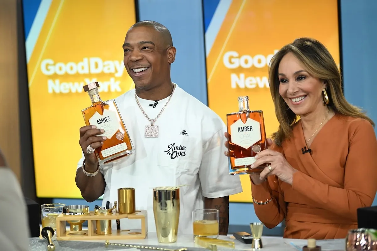 Wearing a white tee shirt and jeans, Ja Rule promotes his whiskey brand with Good Day New York co-host Rosanna Scott