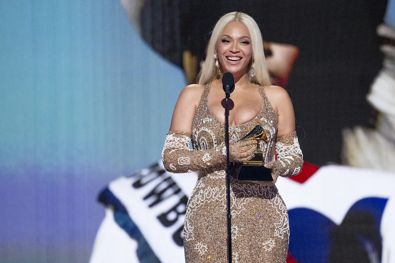 Beyoncé onstage smiling with an award at the 67th Annual GRAMMY Awards